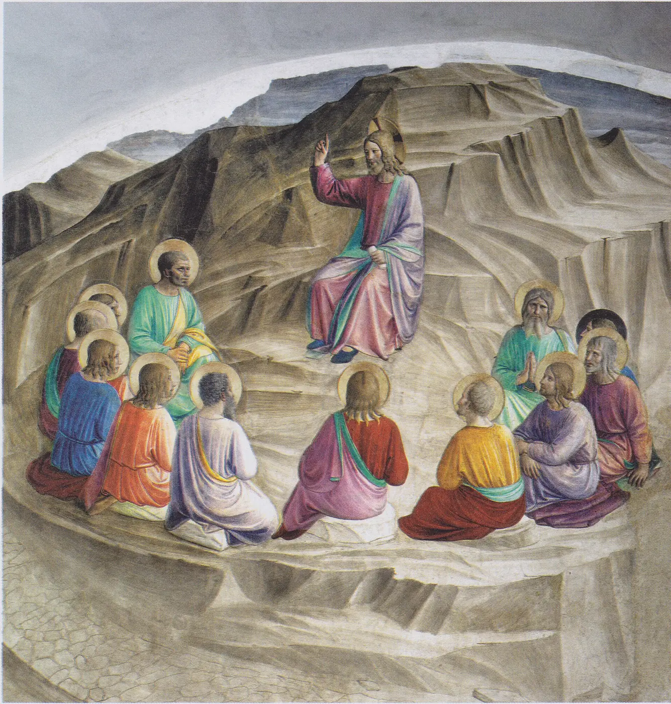 Jesus sits upon a rocky height and teaches a semicircle of disciples gathered below him.